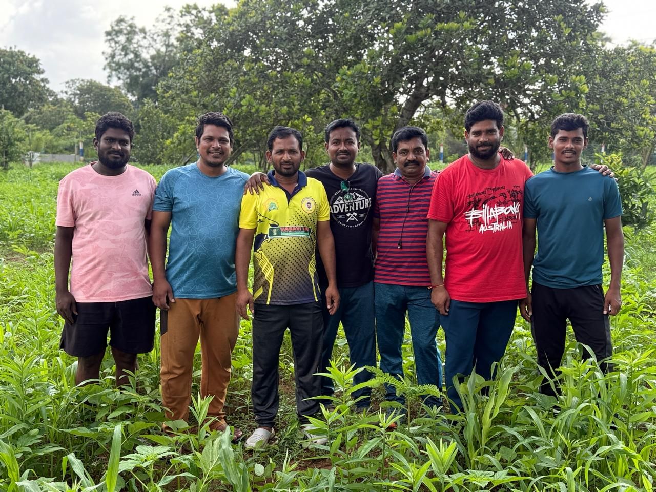 Foundation members and farm helpers standing in a green cover crop
