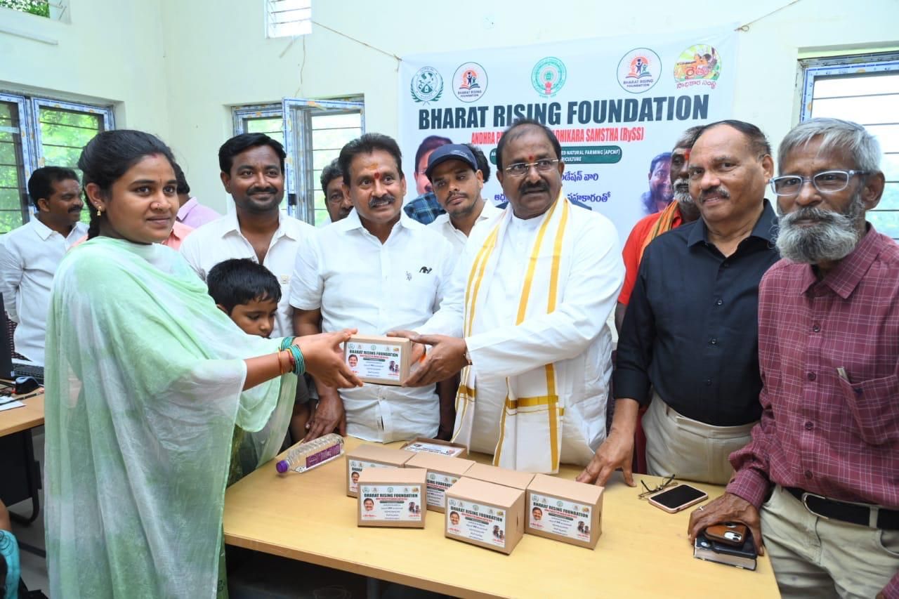 Kitchen garden seed kit boxes being handed over to a woman farmer